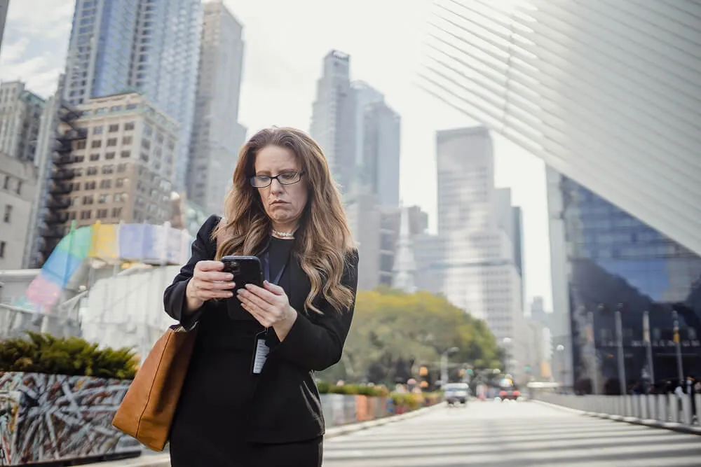 Woman using her phone to use a website